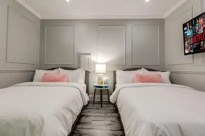 two beds sitting next to each other in a room at The Westlake in Toronto