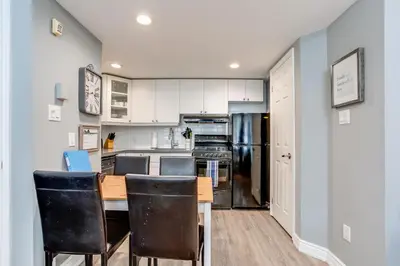 a kitchen with a wooden table and chairs at Blue Mountain Getaway at North Creek Resort King Bed in Blue Mountains