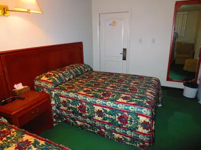 a hotel room with two beds and a table at Canadiana Motel in Hanover