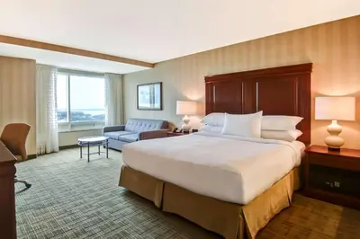 a hotel room with a large bed and a couch at DoubleTree Fallsview Resort & Spa by Hilton - Niagara Falls in Niagara Falls