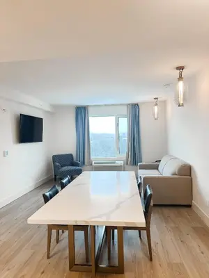 a living room with a table and a couch at Living Stone Golf Resort in Collingwood