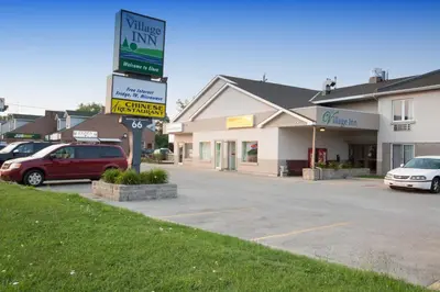 a street sign in front of a car dealership at The Village Inn in Elora