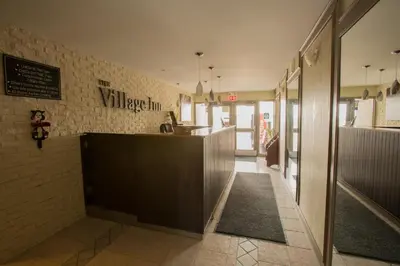 a restaurant with a counter in the middle of a hallway at The Village Inn in Elora