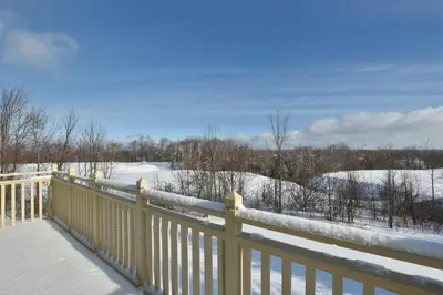 a yellow fence in the snow with a snow covered field at The Blue Escape Blue Mountain Chalet in Blue Mountains