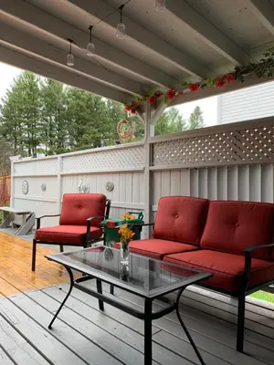 a patio with two red couches and a table at Evening Shade in Fergus
