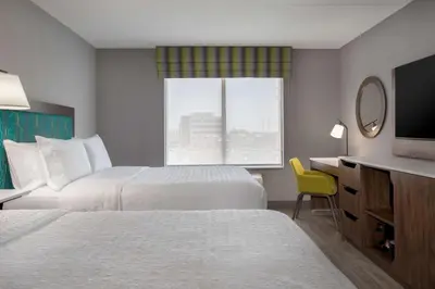 a hotel room with two beds and a window at Hampton Inn by Hilton Brampton - Toronto in Brampton