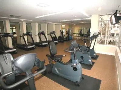a gym with several treadmills and exercise bikes at Mississauga Furnished Apartments in Mississauga