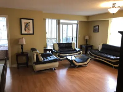 a living room with couches and chairs at Mississauga Furnished Apartments in Mississauga