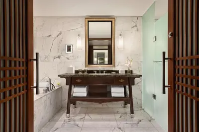 a bathroom with a sink and a mirror at Shangri-La Toronto in Toronto