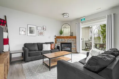 a living room with two couches and a fireplace at Beautiful & Bright 3 Bed Townhome Near Village in Blue Mountains