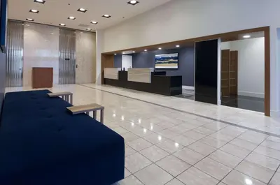 a lobby with a couch in the middle of a room at Doubletree by Hilton London in London