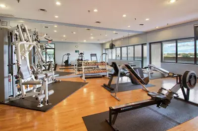 a gym with treadmills and cardio equipment in a building at Doubletree by Hilton London in London