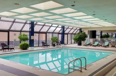 a swimming pool in a building with a ceiling at Doubletree by Hilton London in London