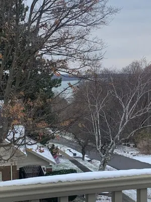 a snow covered yard with a house and trees at The Red Coat in Niagara on the Lake
