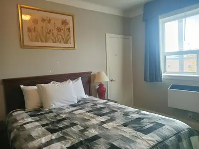 a bedroom with a bed and a window at London Residency Inn in London