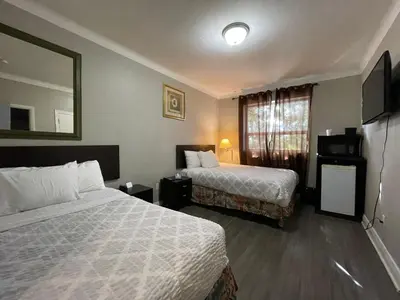 a hotel room with two beds and a window at London Residency Inn in London