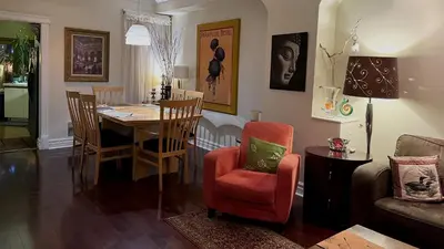 a living room with a dining room table and chairs at A Seaton Dream in Toronto