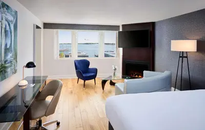 a room with a bed and a living room with a fireplace at Radisson Blu Toronto Downtown in Toronto