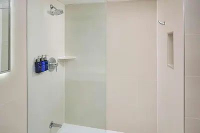 a bathroom with a shower with a glass door at Radisson Blu Toronto Downtown in Toronto