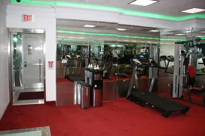 a gym with treadmills and machines in a room at Yonge Suites Apart Hotel in Toronto