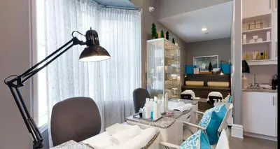 a living room with a table and chairs and a lamp at Idlewyld Inn & Spa in London