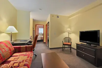 a living room with a couch and a flat screen tv at Super 8 by Wyndham Barrie South in Barrie