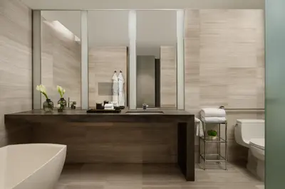 a bathroom with a sink and a tub and a toilet at Four Seasons Hotel Toronto in Toronto