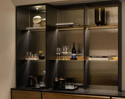 a shelf with glasses and a bottle of wine at Four Seasons Hotel Toronto in Toronto