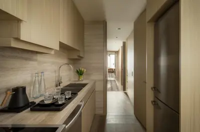a kitchen with a sink and wine glasses on the counter at Four Seasons Hotel Toronto in Toronto