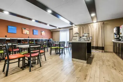 a restaurant with tables and chairs and a bar at Comfort Inn in Owen Sound