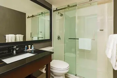 a bathroom with a toilet and a glass shower at Comfort Inn in Cambridge