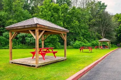 a gazebo with red picnic tables in a park at Comfort Inn in Midland