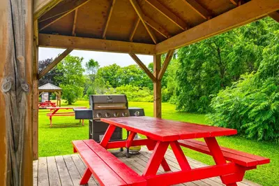 a red picnic table and a grill under a gazebo at Comfort Inn in Midland