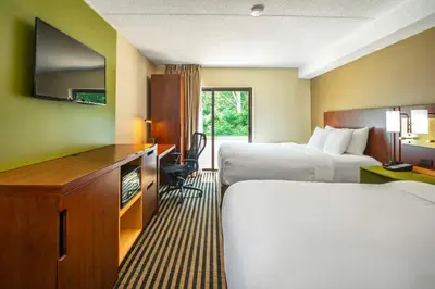 a hotel room with two beds and a television at Comfort Inn in Midland
