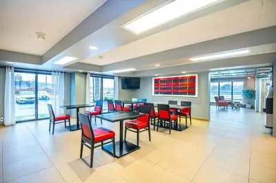 a dining room with tables and red chairs at Quality Inn in Barrie