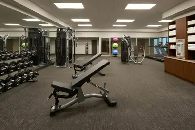a gym with treadmills and machines at Courtyard by Marriott Oshawa in Oshawa