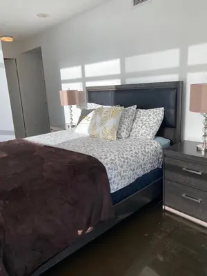 a bedroom with a large bed and a night stand at Toronto Downtown Luxurious Stylish 3 Bedroom 3 Bath 2 Balconies near Rogers Centre lakeview condo in Toronto