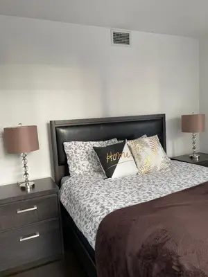 a bedroom with a bed with pillows and two lamps at Toronto Downtown Luxurious Stylish 3 Bedroom 3 Bath 2 Balconies near Rogers Centre lakeview condo in Toronto
