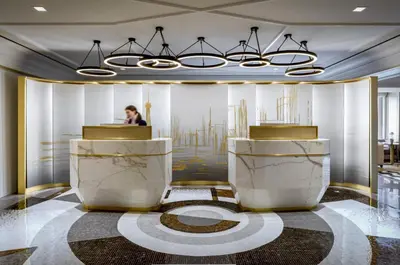 a man is sitting at a podium in a lobby at Fairmont Royal York Gold Experience in Toronto
