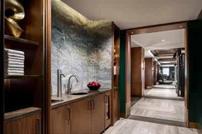 a bathroom with a sink and a hallway at Fairmont Royal York Gold Experience in Toronto