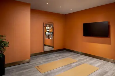 a room with orange walls and a flat screen tv at Fairmont Royal York Gold Experience in Toronto