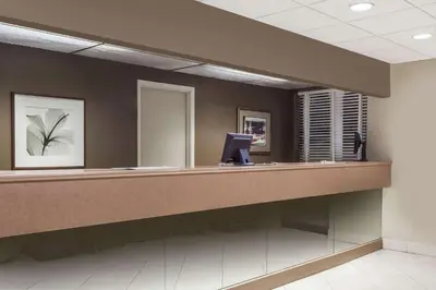 a lobby with a reception desk in a building at Howard Johnson by Wyndham Niagara Falls in Niagara Falls
