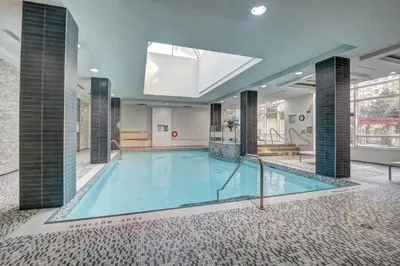 a large swimming pool in the middle of a building at Bombay Suites Mississauga in Mississauga