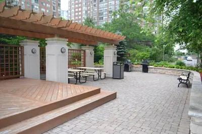 a pavilion with benches and tables in a park at Bombay Suites Mississauga in Mississauga