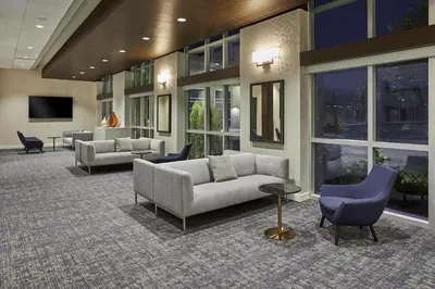 a lobby with couches and chairs in a building at Hyatt Place Toronto Mississauga and Luxe Convention Centre in Mississauga