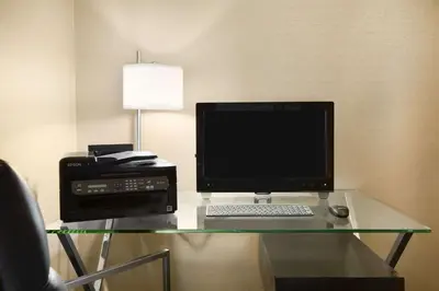 a desk with a computer monitor and a printer at Days Inn by Wyndham Stouffville in Stouffville