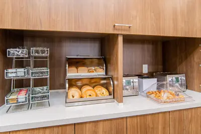 a kitchen with a bunch of pastries on a counter at TownePlace Suites by Marriott Brantford and Conference Centre in Brantford