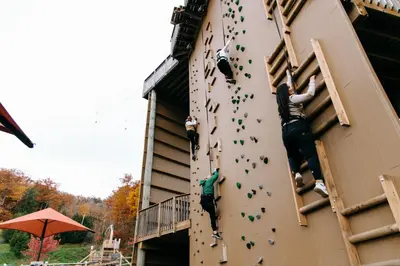 a group of people on the climbing wall of a building at Blue Mountain Resort Inn in Blue Mountains