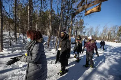 a group of people walking in the snow at Blue Mountain Resort Home Collection in Blue Mountains