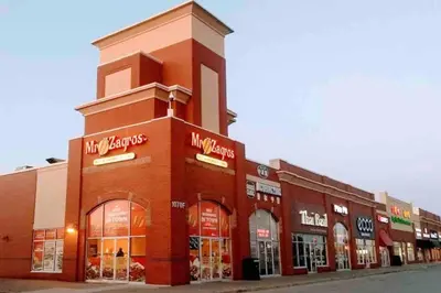 a large brick building on a street with stores at Amazing Spacious house in Center of Richmond hill in Richmond Hill